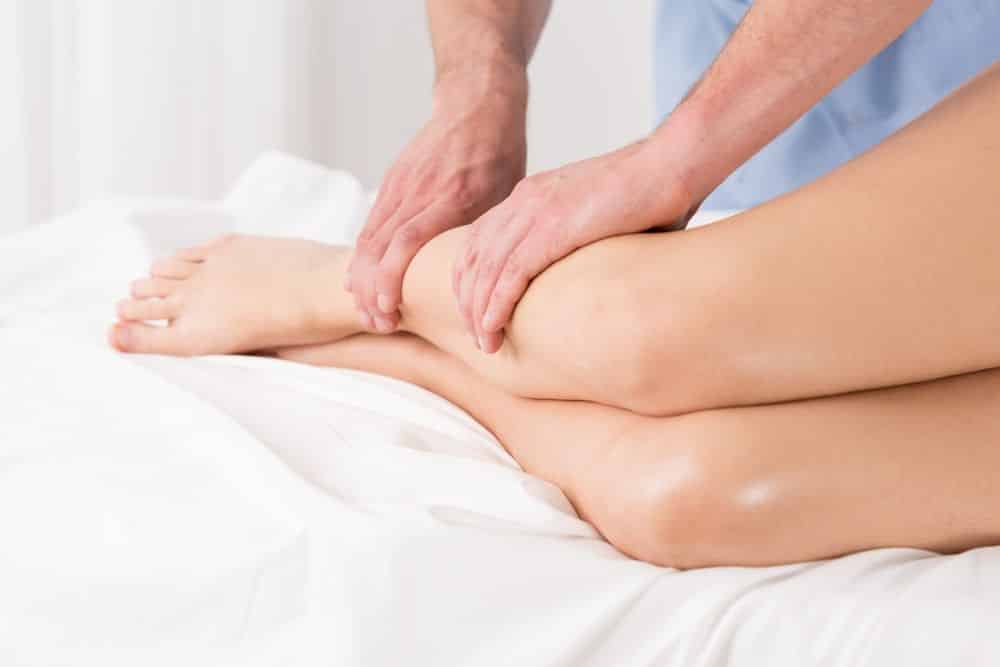 Physical therapist doing lymphatic drainage for the legs